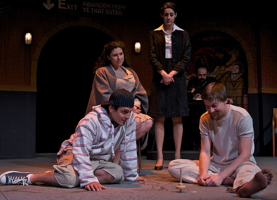 Louis Farber (in background), Meg Sullivan (standing), and Andrea Morales (in chair) watch, from left, Marcelino Quiñonez and Tyler Eglen in memory, in The Last Days of Judas Iscariot. (Photo by John Groseclose)