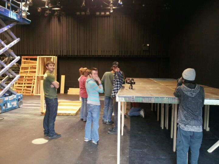 David Weiss may be the technical director at Nearly Naked Theatre, but the title doesn't keep him from getting down to the nitty gritty of building sets. That's his legs you see under the platform. (Photo from the David Weiss Collection)